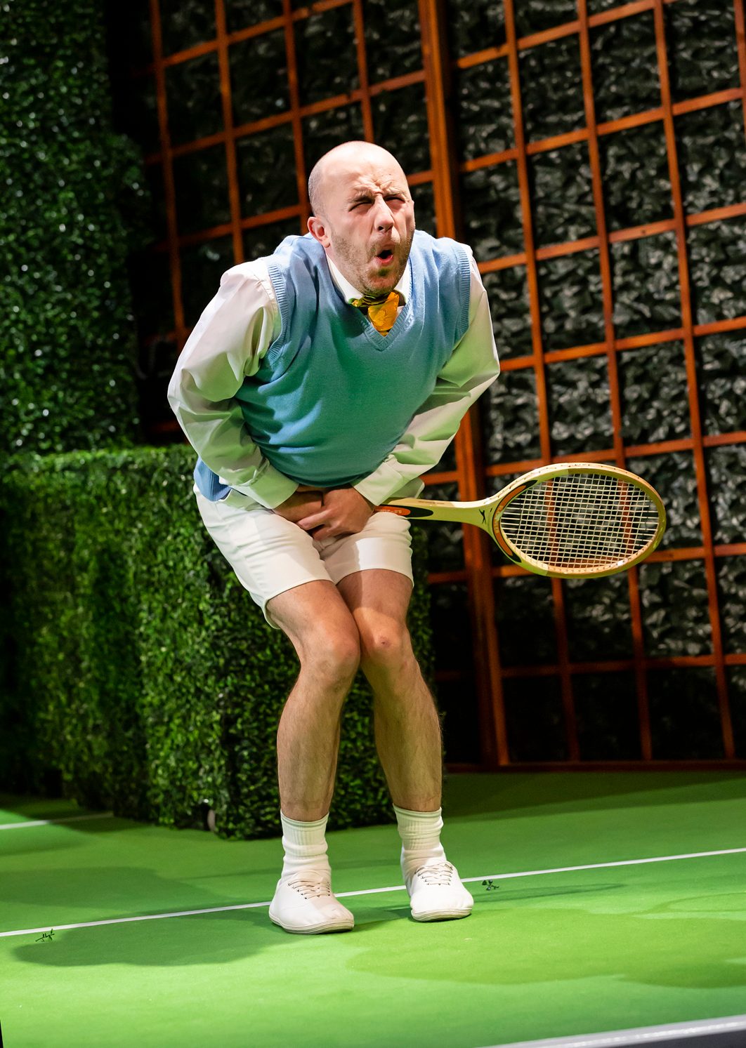 Crimes On Centre Court A male character holding a tennis racket is in pain after being hit between the legs.