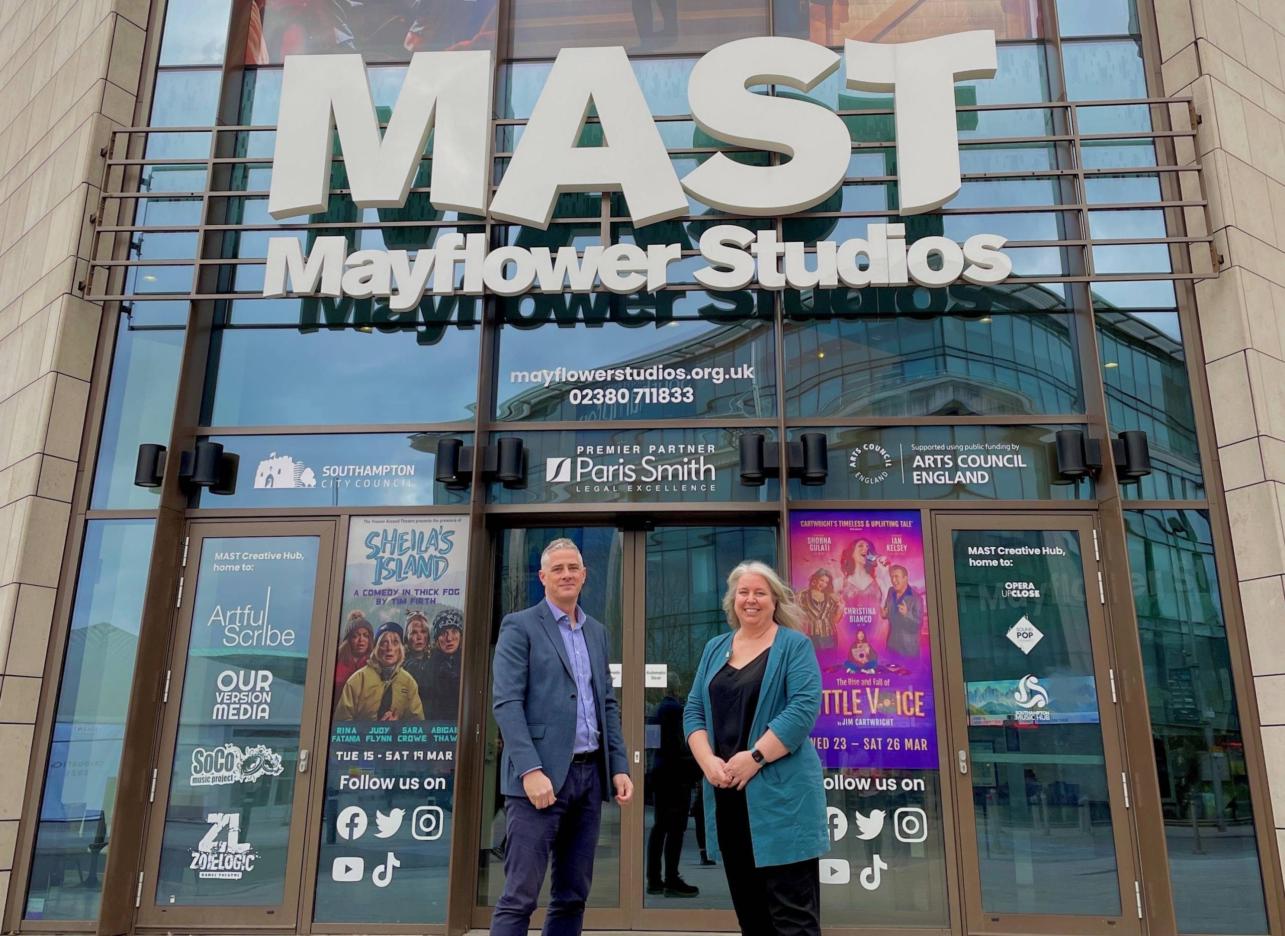 Brooks Macdonald Sara Scott and Brooks Macdonald representative stand outside MAST looking at the camera.