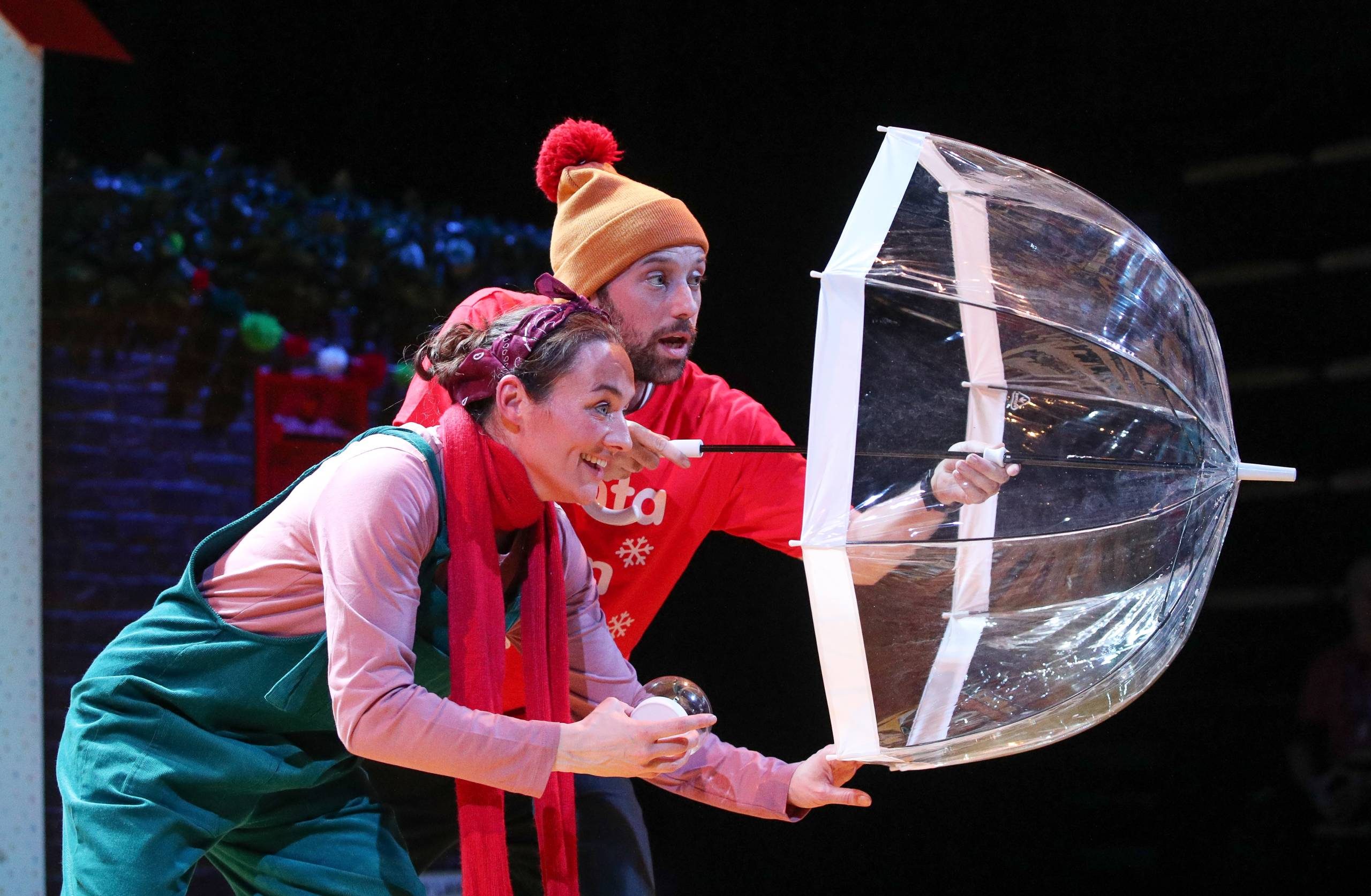 Counting Down to Christmas Male and female character hide behind an umbrella.