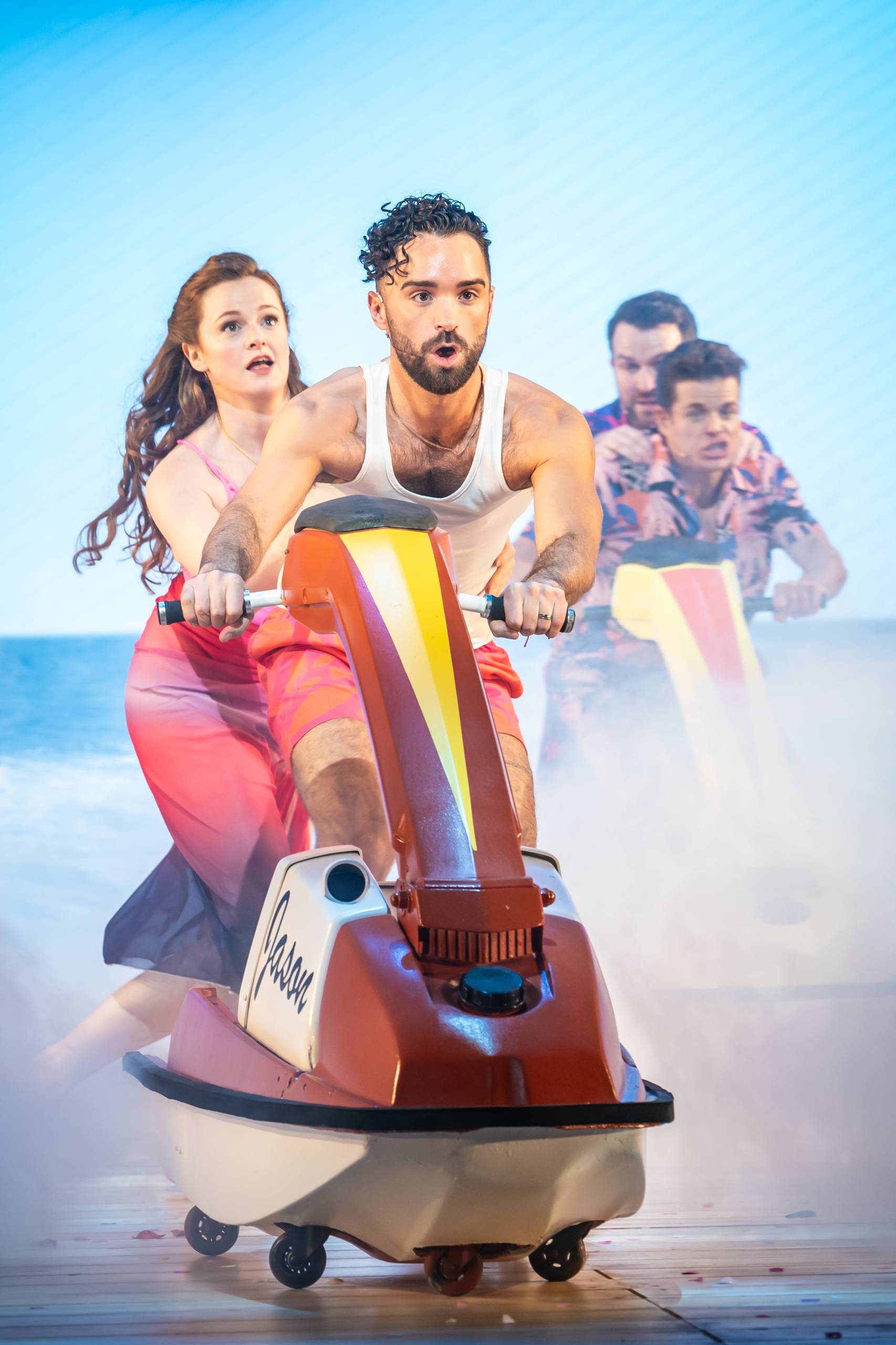 I Should Be So Lucky A male and female are on a jet ski named 'Jason' whilst being chased by two other males on another jet ski