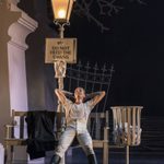 Swan Lake Prince on bench Liam Mower 'The Prince' reclines on a park bench below sign Do Not Feed The Swans