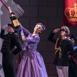 Swan Lake ship send off Nicole Kabera 'The Queen' holds a champagne bottle on a rope ready to send a ship off as Dominic North 'The Prince' and other soldiers salute