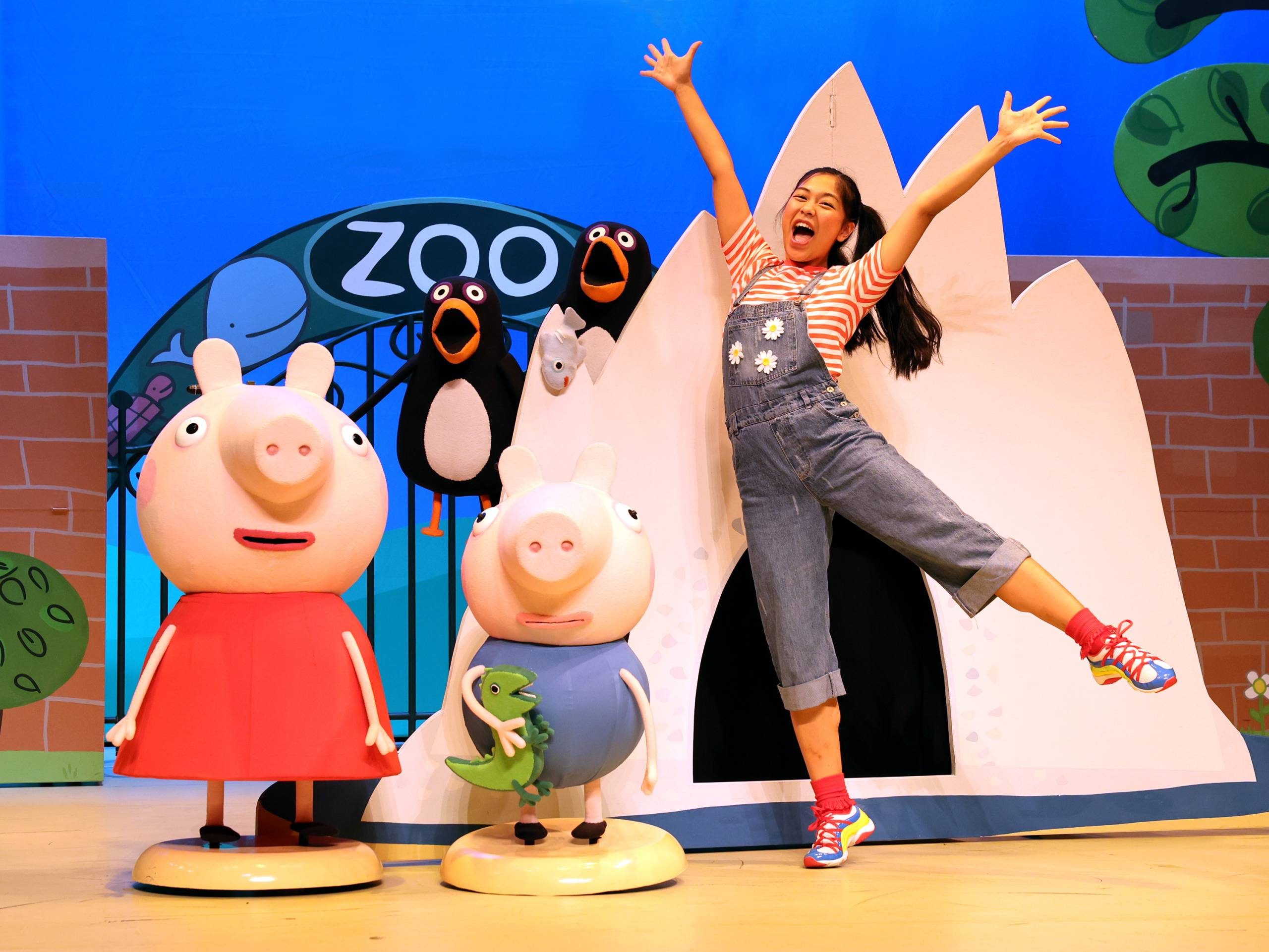 Peppa Pig's Fun Day Out Female character is celebrating with Peppa Pig, George and penguins.
