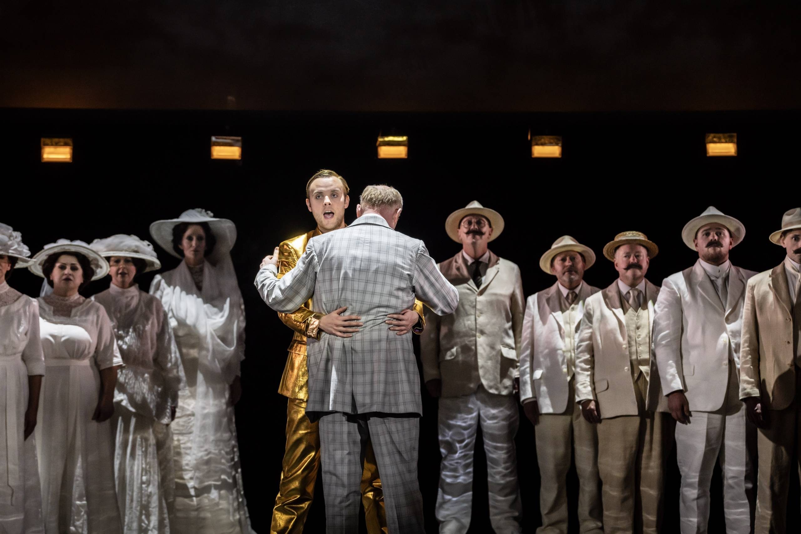 Death in Venice Apollo and Aschenbach Apollo (Alexander Chance) hugs Aschenbach as the ensemble watches on.